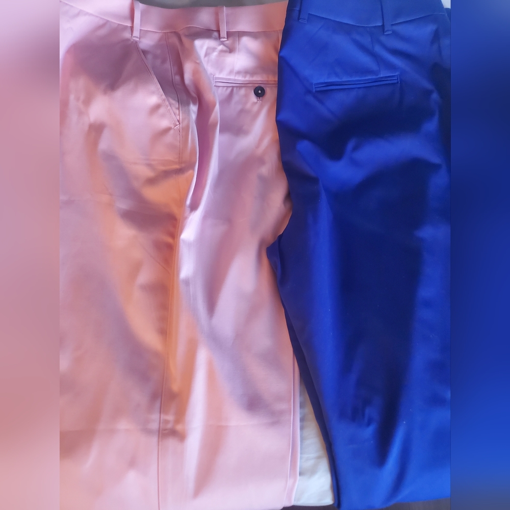 A pair of chinos that are a pale pink and royal blue in color.